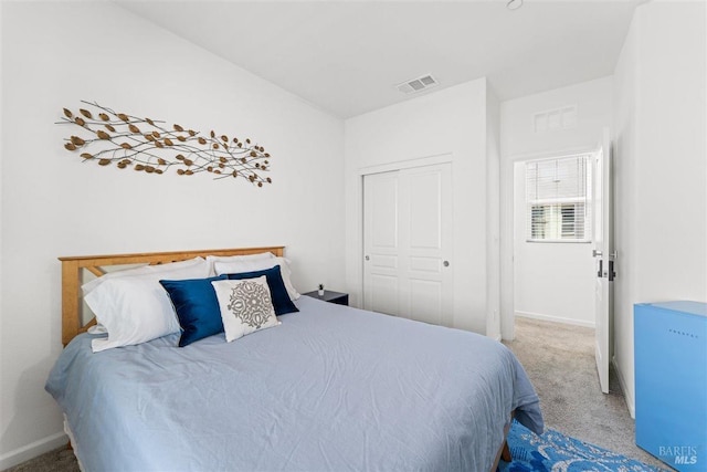 bedroom with visible vents, baseboards, a closet, and carpet