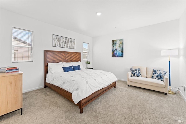 bedroom with light carpet and baseboards