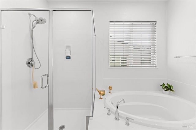 full bath with a bath and a stall shower