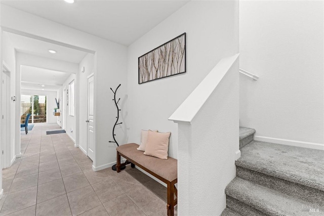 entryway featuring recessed lighting, baseboards, and stairs