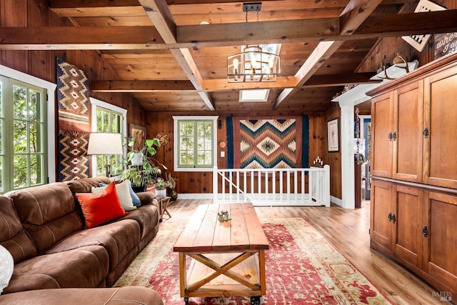 living room featuring wood ceiling, an inviting chandelier, light wood-style flooring, and wooden walls