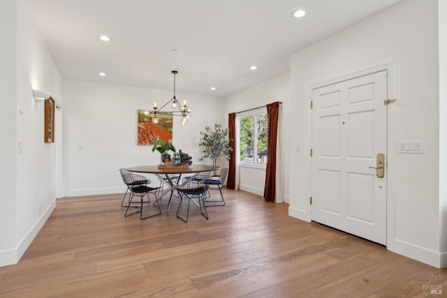 dining area with a chandelier, light wood-type flooring, baseboards, and recessed lighting