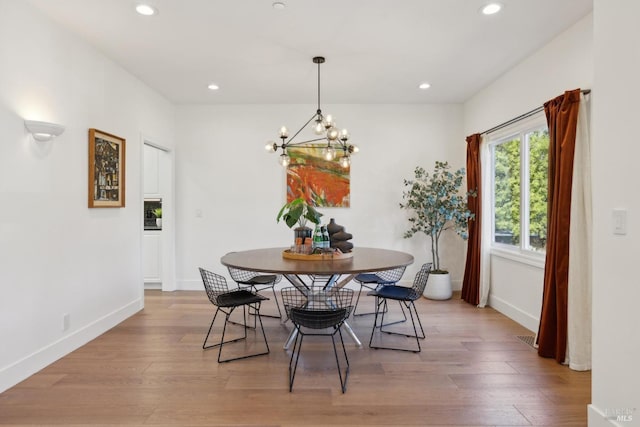 dining area featuring baseboards, wood finished floors, and recessed lighting