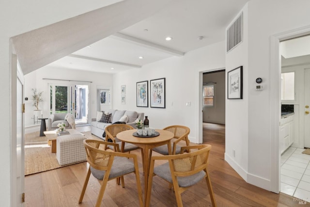 dining space with beamed ceiling, wood finished floors, visible vents, and recessed lighting