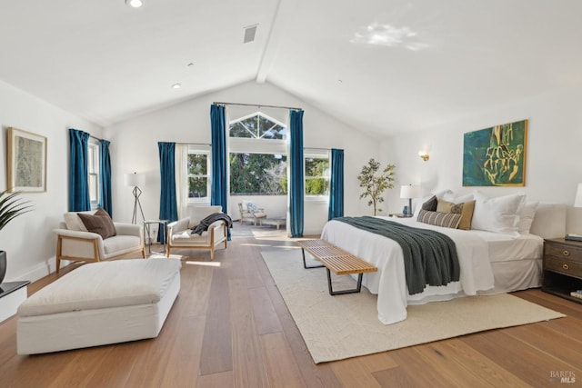 bedroom featuring visible vents, vaulted ceiling with beams, baseboards, and wood finished floors