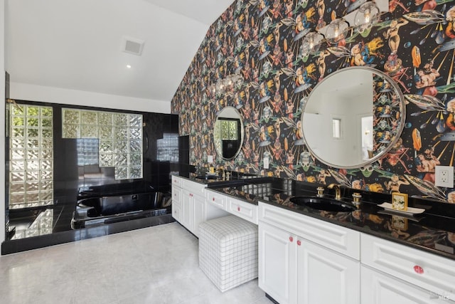 bathroom featuring wallpapered walls, visible vents, tile patterned flooring, vaulted ceiling, and vanity