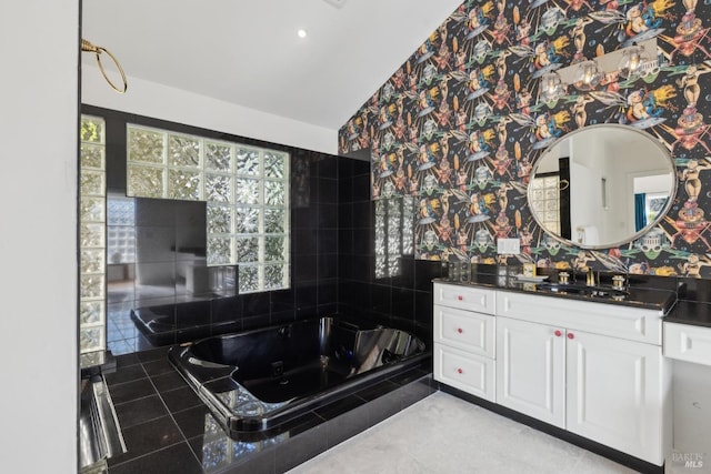 full bathroom featuring a jetted tub and vanity