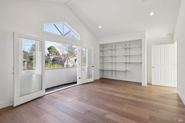 interior space with high vaulted ceiling, hardwood / wood-style flooring, recessed lighting, baseboards, and built in features