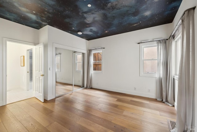 1211 Grand Ave, San Rafael, CA 94901 - unfurnished bedroom featuring wood-type flooring, baseboards, and a closet