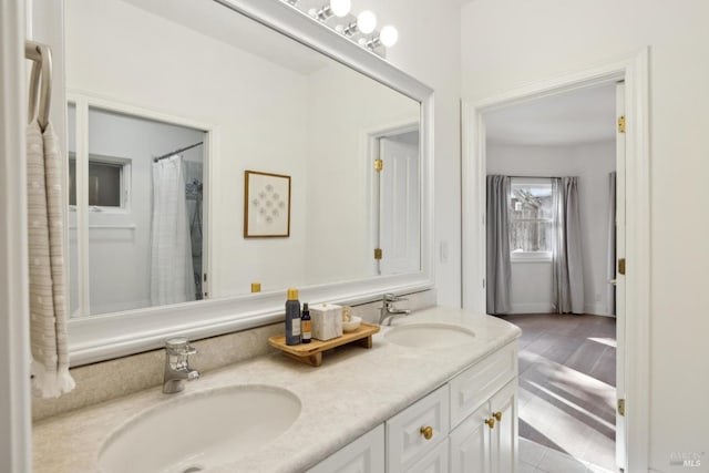 bathroom with a sink and double vanity