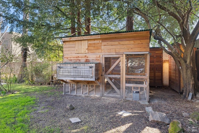 view of poultry coop featuring fence