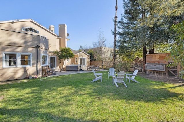 view of yard featuring entry steps, a jacuzzi, a patio, and fence