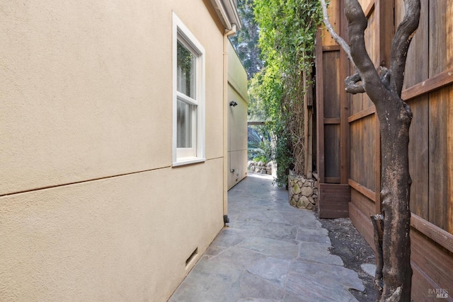 view of side of property with a patio and stucco siding