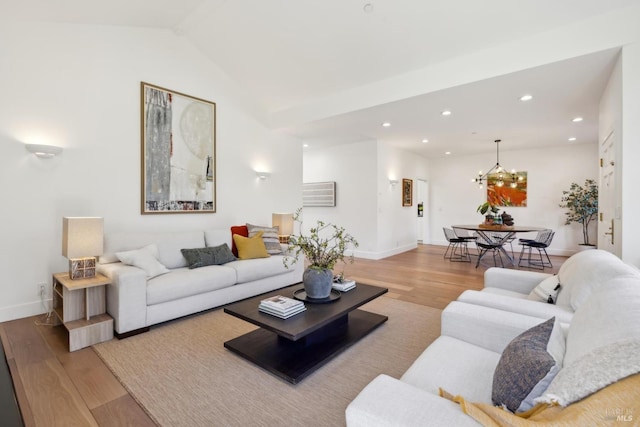 living area with baseboards, wood finished floors, vaulted ceiling, a notable chandelier, and recessed lighting