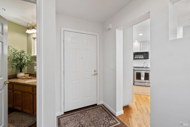 entryway featuring light wood-style flooring and baseboards