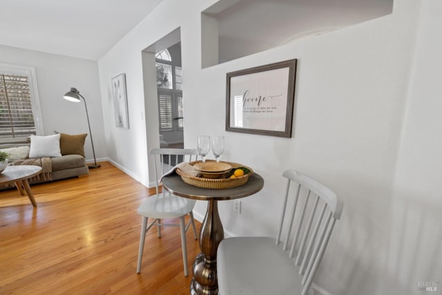 sitting room featuring a healthy amount of sunlight, baseboards, and wood finished floors