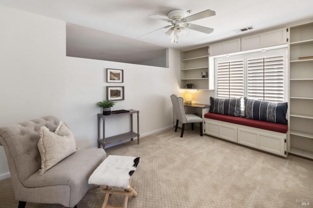 living area with light carpet, ceiling fan, visible vents, and baseboards