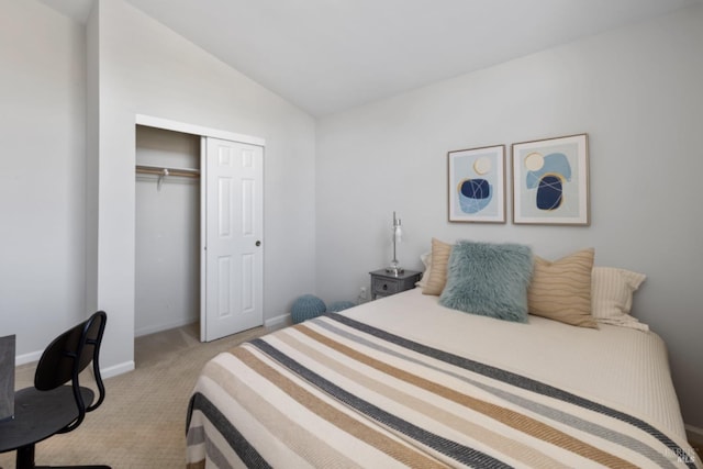 bedroom featuring lofted ceiling, light carpet, baseboards, and a closet
