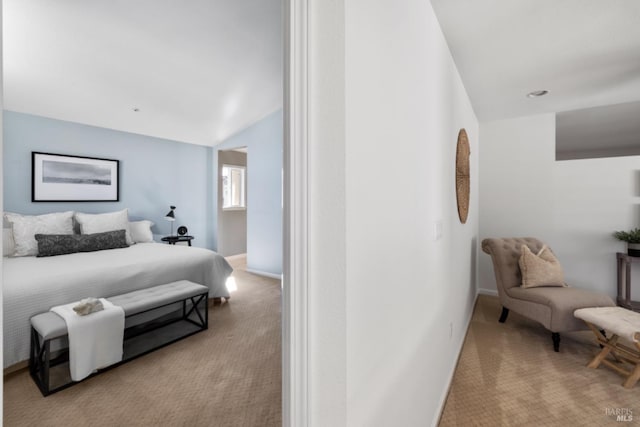 carpeted bedroom with lofted ceiling and baseboards