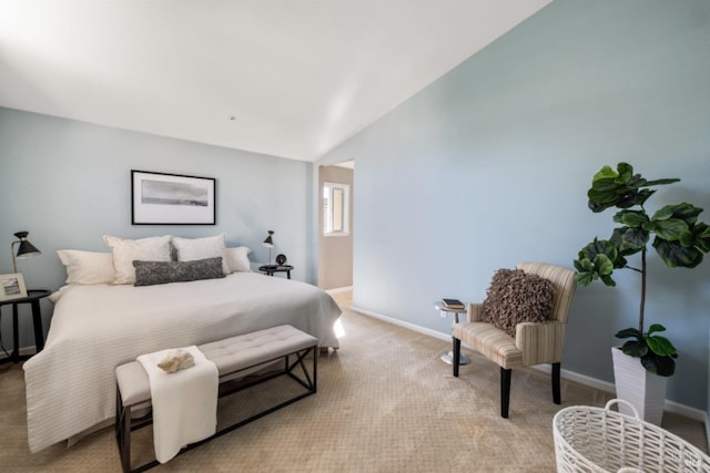 carpeted bedroom featuring lofted ceiling and baseboards