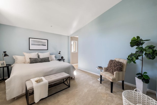 bedroom with vaulted ceiling, carpet flooring, and baseboards