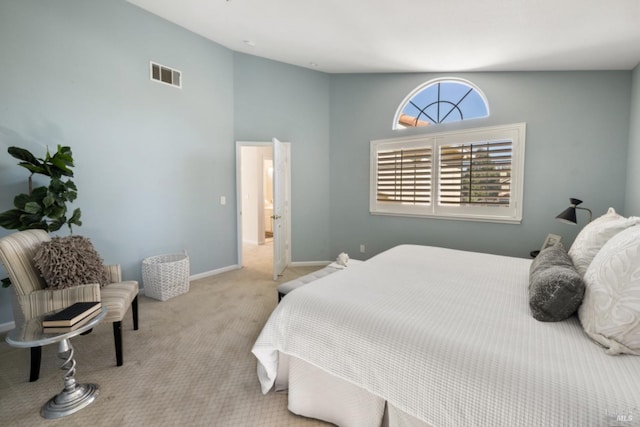 bedroom with lofted ceiling, carpet, visible vents, and baseboards