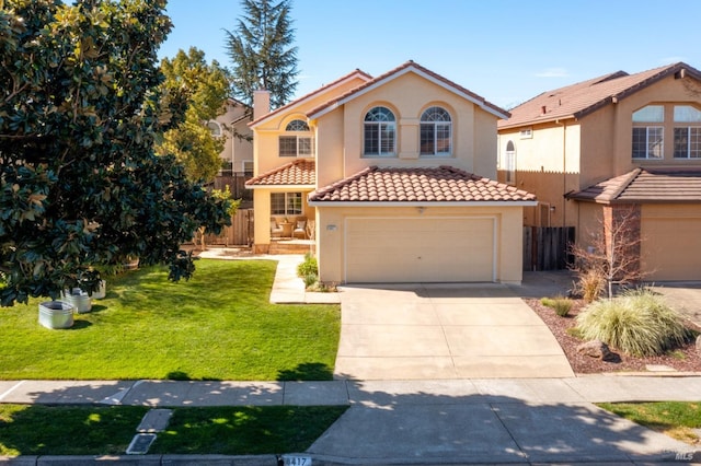 mediterranean / spanish house featuring a tile roof, concrete driveway, fence, a front yard, and stucco siding