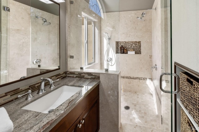 full bath with a shower stall, vanity, and decorative backsplash