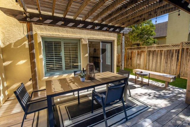 deck featuring fence, a pergola, and outdoor dining area