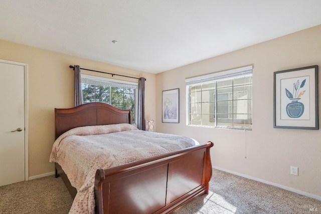 bedroom with carpet flooring and baseboards