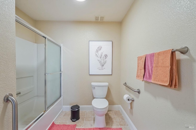 full bathroom with tile patterned flooring, visible vents, baseboards, toilet, and combined bath / shower with glass door