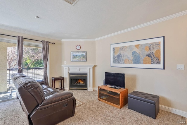 carpeted living room featuring visible vents, baseboards, a glass covered fireplace, and ornamental molding
