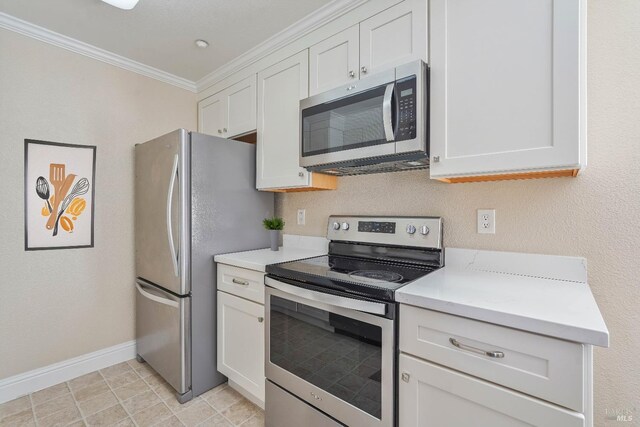kitchen featuring baseboards, stainless steel appliances, light countertops, white cabinets, and crown molding