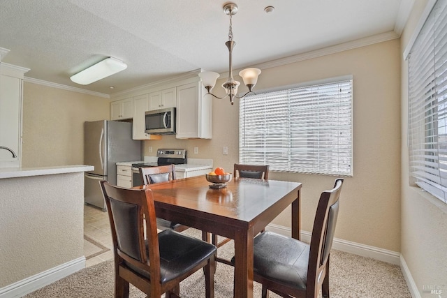 dining room featuring a notable chandelier, a textured ceiling, crown molding, and baseboards