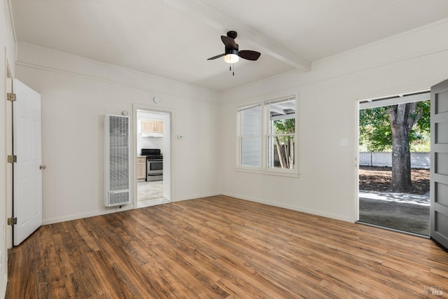 empty room with baseboards, a ceiling fan, wood finished floors, and beamed ceiling