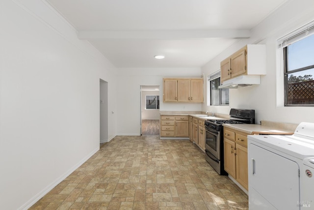 kitchen with stainless steel gas range, light countertops, light brown cabinetry, under cabinet range hood, and separate washer and dryer