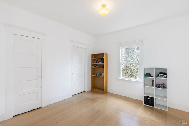 interior space with wood finished floors and baseboards