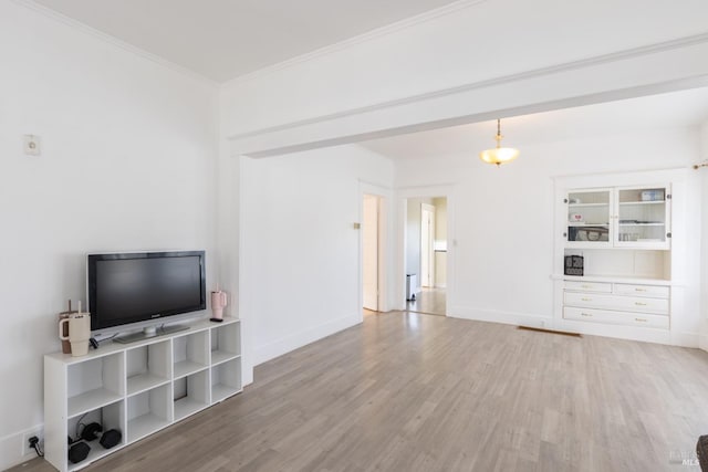 living room with ornamental molding, light wood-type flooring, and baseboards