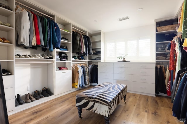 spacious closet featuring wood finished floors and visible vents