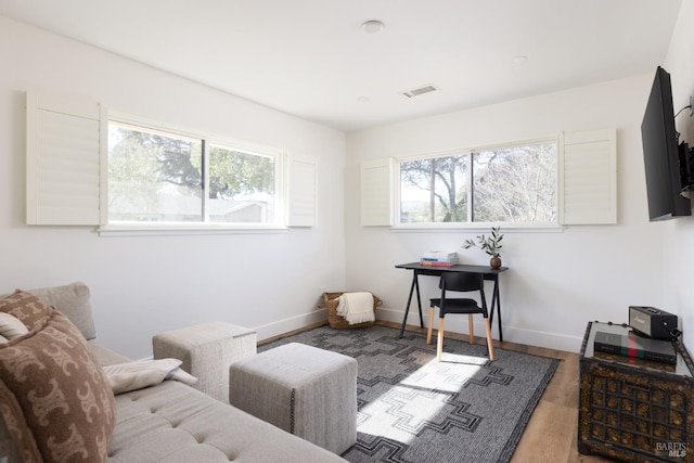 interior space with visible vents, baseboards, and wood finished floors