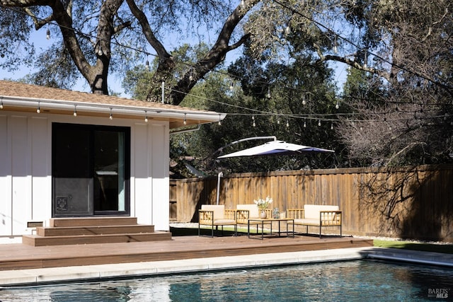 view of pool featuring entry steps, a deck, fence, and a fenced in pool