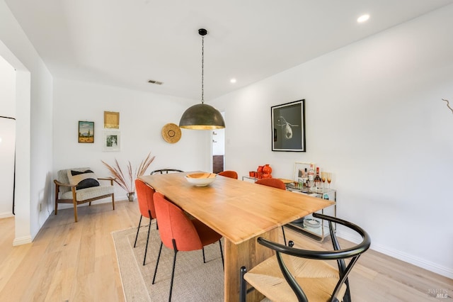 dining room featuring light wood-type flooring, baseboards, and recessed lighting