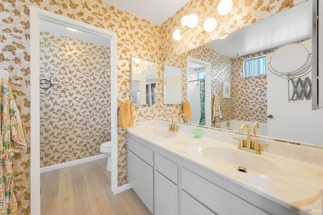 full bathroom featuring a sink and wallpapered walls