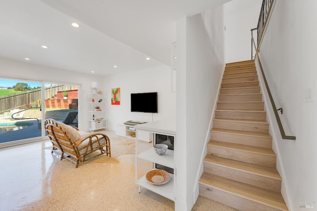 stairs featuring recessed lighting