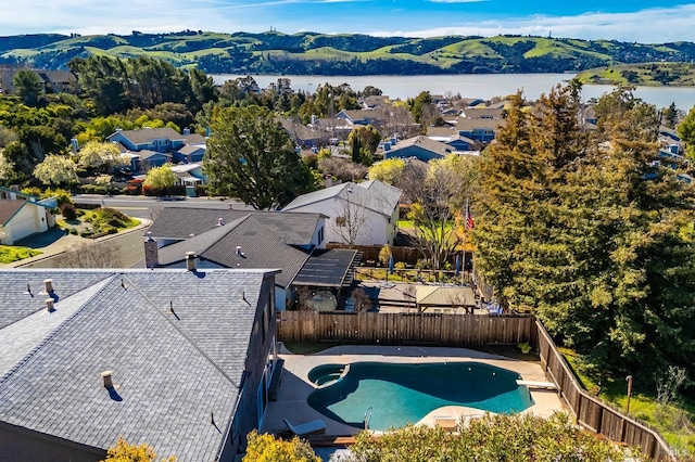 drone / aerial view featuring a residential view and a water view