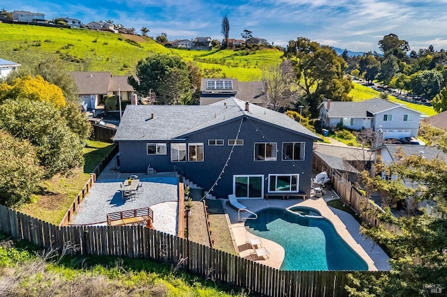 exterior space featuring a patio area, a fenced backyard, and a residential view