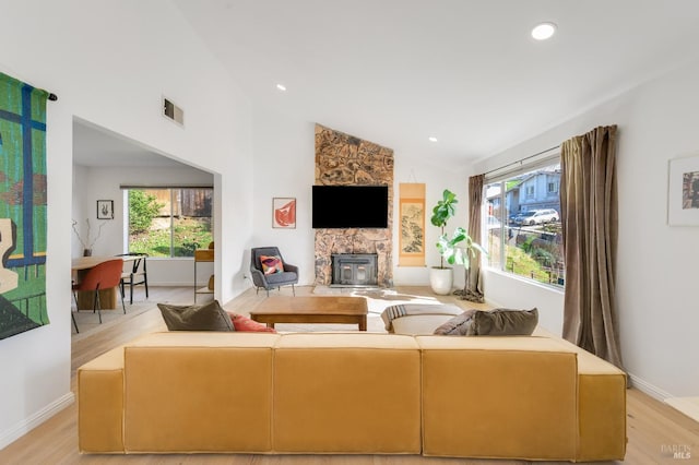 living area featuring high vaulted ceiling, light wood-style flooring, recessed lighting, visible vents, and baseboards