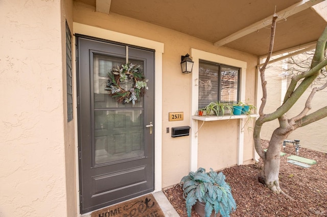 property entrance featuring stucco siding