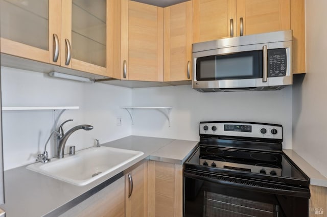 kitchen with range with electric cooktop, stainless steel microwave, light brown cabinets, open shelves, and a sink