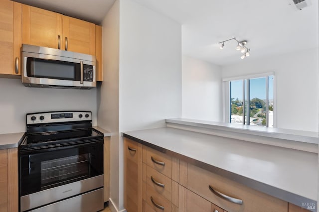 95 Anchorage Rd Unit 95, Sausalito, CA 94965 - kitchen with stainless steel appliances, light brown cabinets, and track lighting